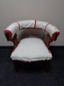 An antique carved oak armchair on brass capped feet