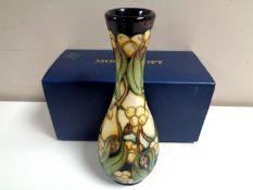 A Moorcroft Mistletoe pattern vase, height 20cm, boxed.