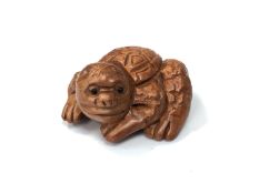 A carved Chinese hardwood netsuke - Mythical creature