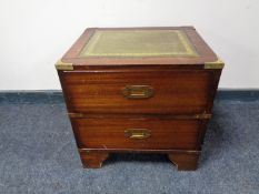 A ship's style two drawer bedside chest with green tooled leather inset panel