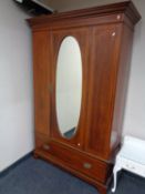 A late Victorian inlaid mahogany mirror door wardrobe fitted a drawer beneath