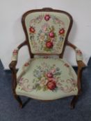 A carved beech salon armchair in tapestry fabric