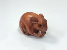 A carved Chinese hardwood netsuke - rat feeding