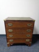 A ship's style four drawer chest with green tooled leather inset panel