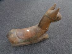 A carved miniature wooden rocking horse