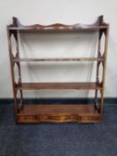 A reproduction mahogany wall shelf fitted three drawers