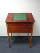 An early 20th century mahogany clerk's desk fitted two drawers beneath on raised legs