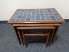 A nest of three mid 20th century teak tile top tables