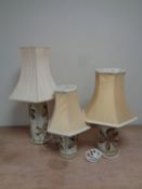 Three graduated pottery table lamps with shades