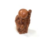 A carved Chinese hardwood netsuke - Village elder with club