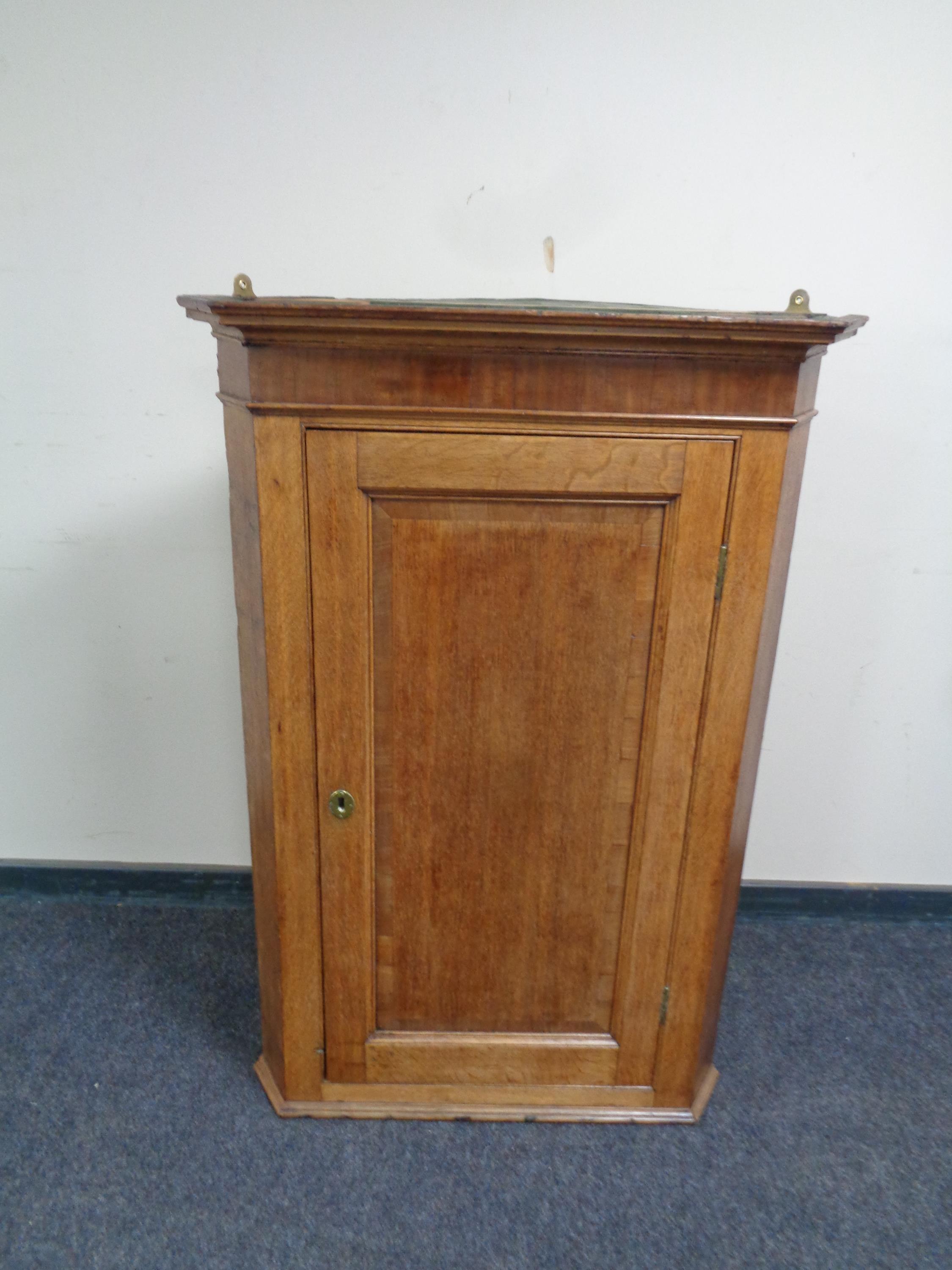 A 19th century oak hanging corner cabinet