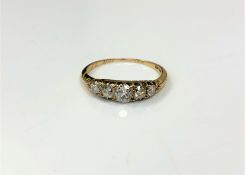 A late Victorian 18ct gold five stone diamond ring, with inscription to shank dated 1886, size N.