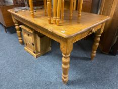 A pine farmhouse style dining table fitted a drawer
