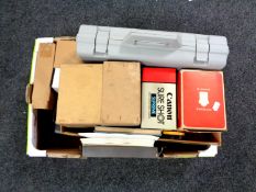 A box containing camera equipment, German language tapes,