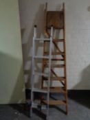 An aluminium extension ladder together with a wooden folding ladder