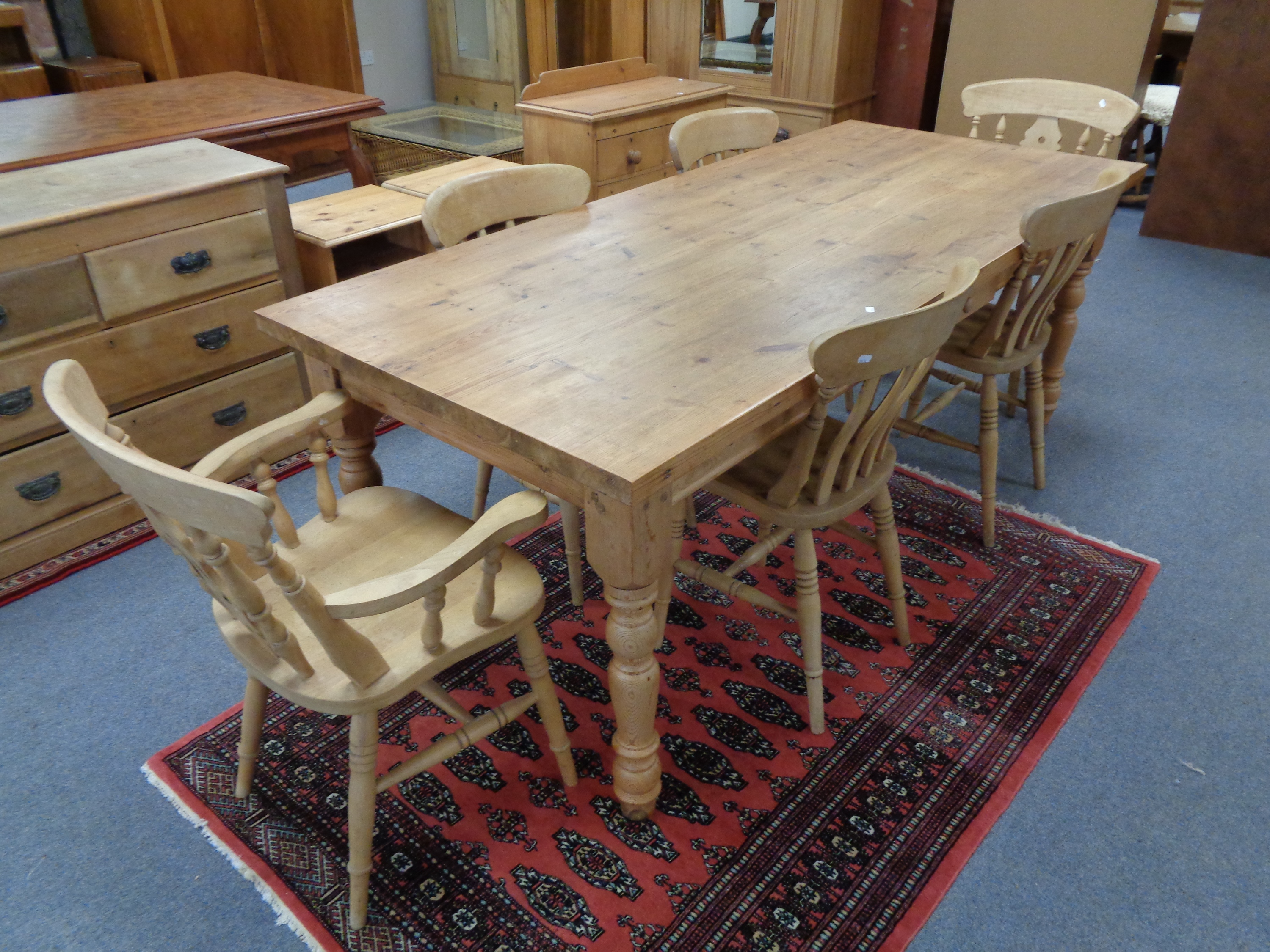 A pine farmhouse style dining table and six chairs (2 carvers and four singles)