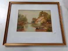 An S J Tate watercolour depicting a cottage by a stream signed and dated 1918