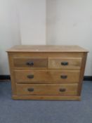 An Edwardian pine chest of four drawers