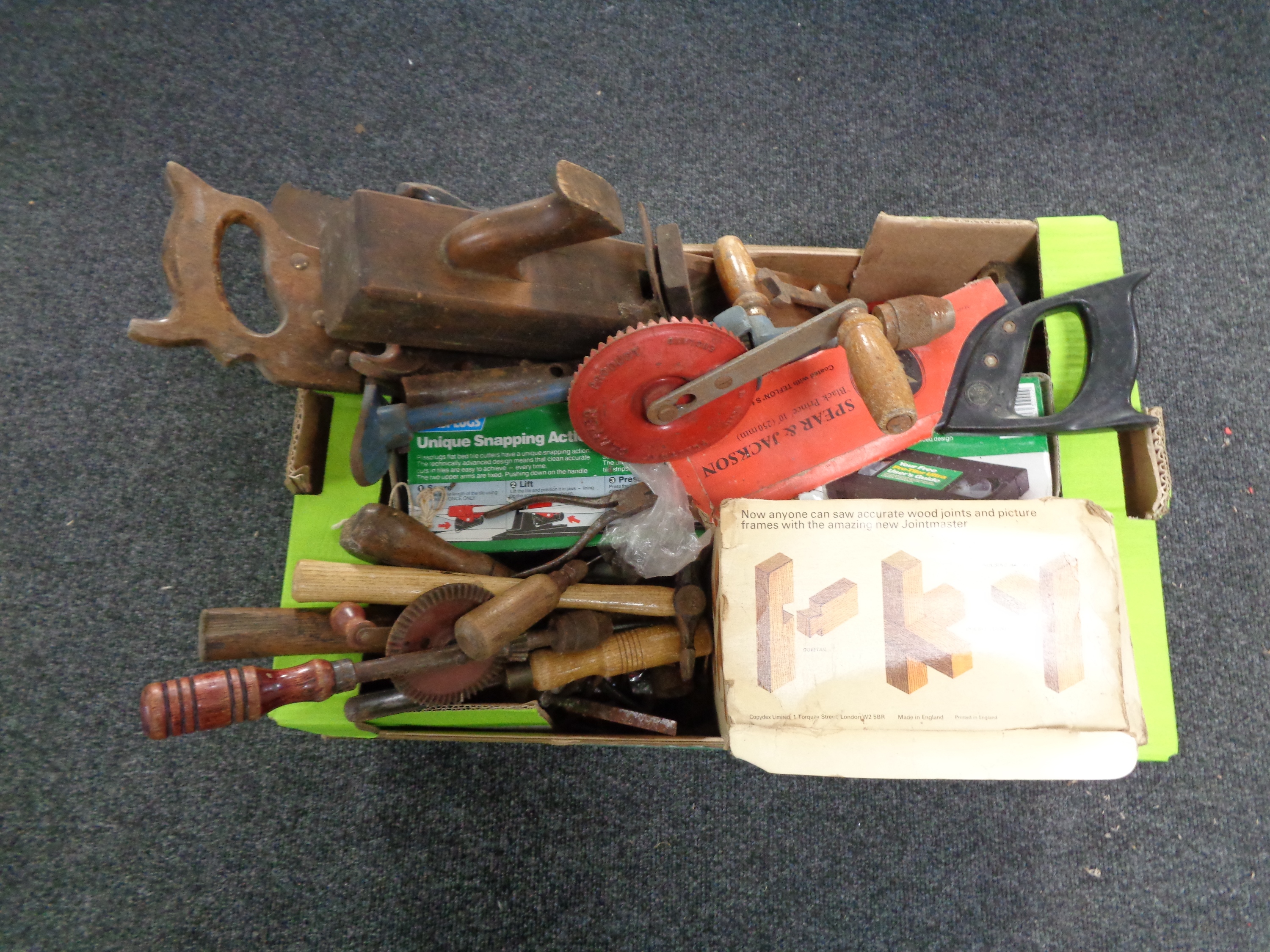 A box containing a quantity of hand tools, drills,