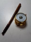 A brass cased ship's style barometer together with a turned wooden truncheon