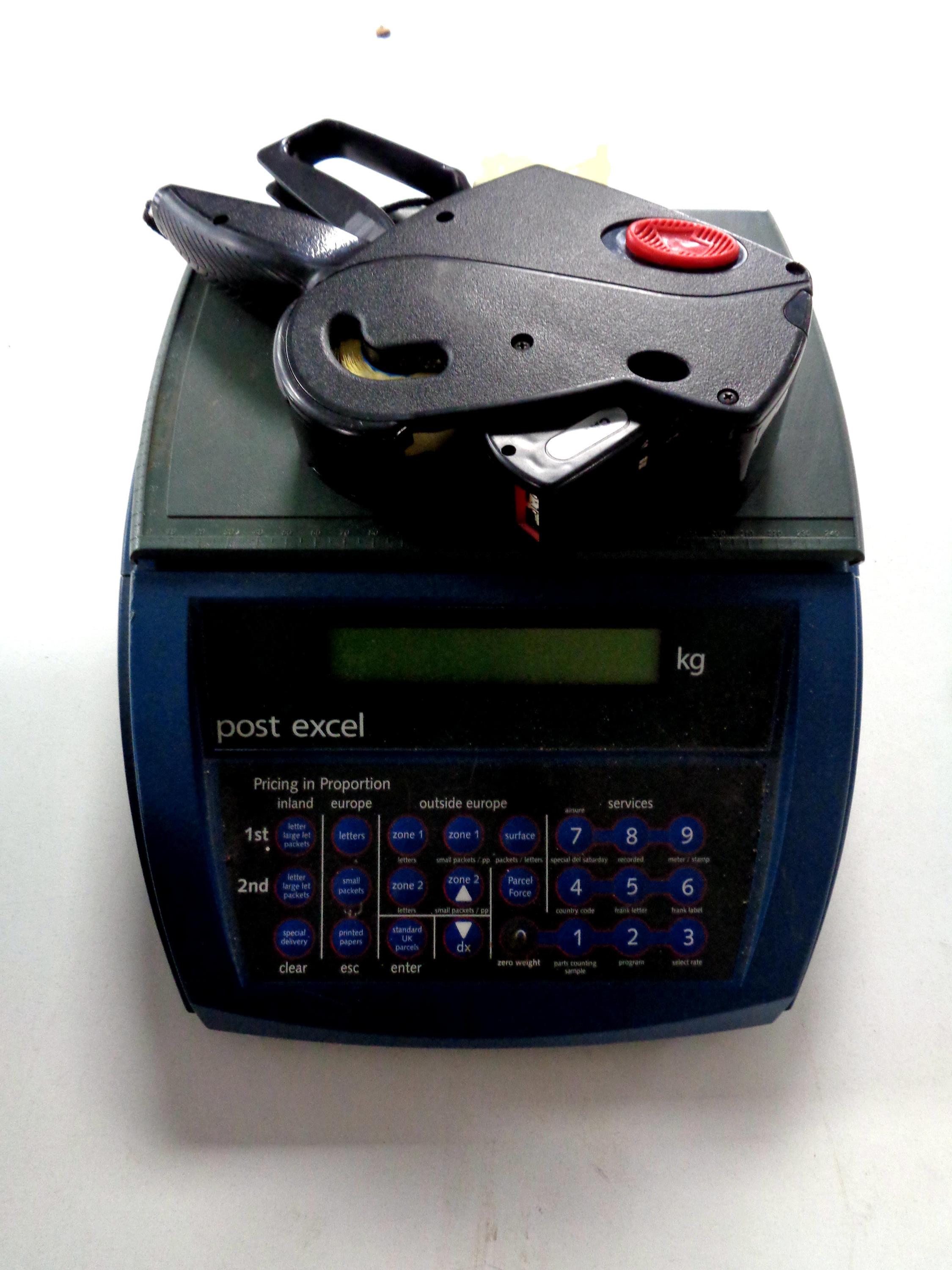 A set of electronic postal scales together with a tally gun