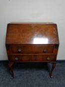 A walnut fall front writing bureau fitted two drawers