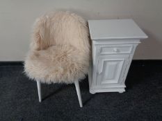 A white painted bedside chest together with a contemporary chair