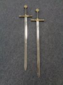 A reproduction pair of long swords marked Excalibur
