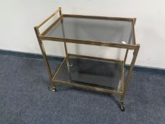 A brass and glass serving trolley