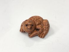A carved Chinese hardwood netsuke - Mythical beast