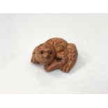 A carved Chinese hardwood netsuke - Mythical beast