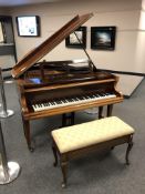 A baby grand piano by Beulhoff in a mahogany case, width 141 cm,