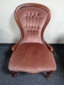 A Victorian mahogany nursing chair in buttoned upholstery