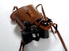 A pair of leather cased field glasses marked S L Paris Luximor 8 x 25