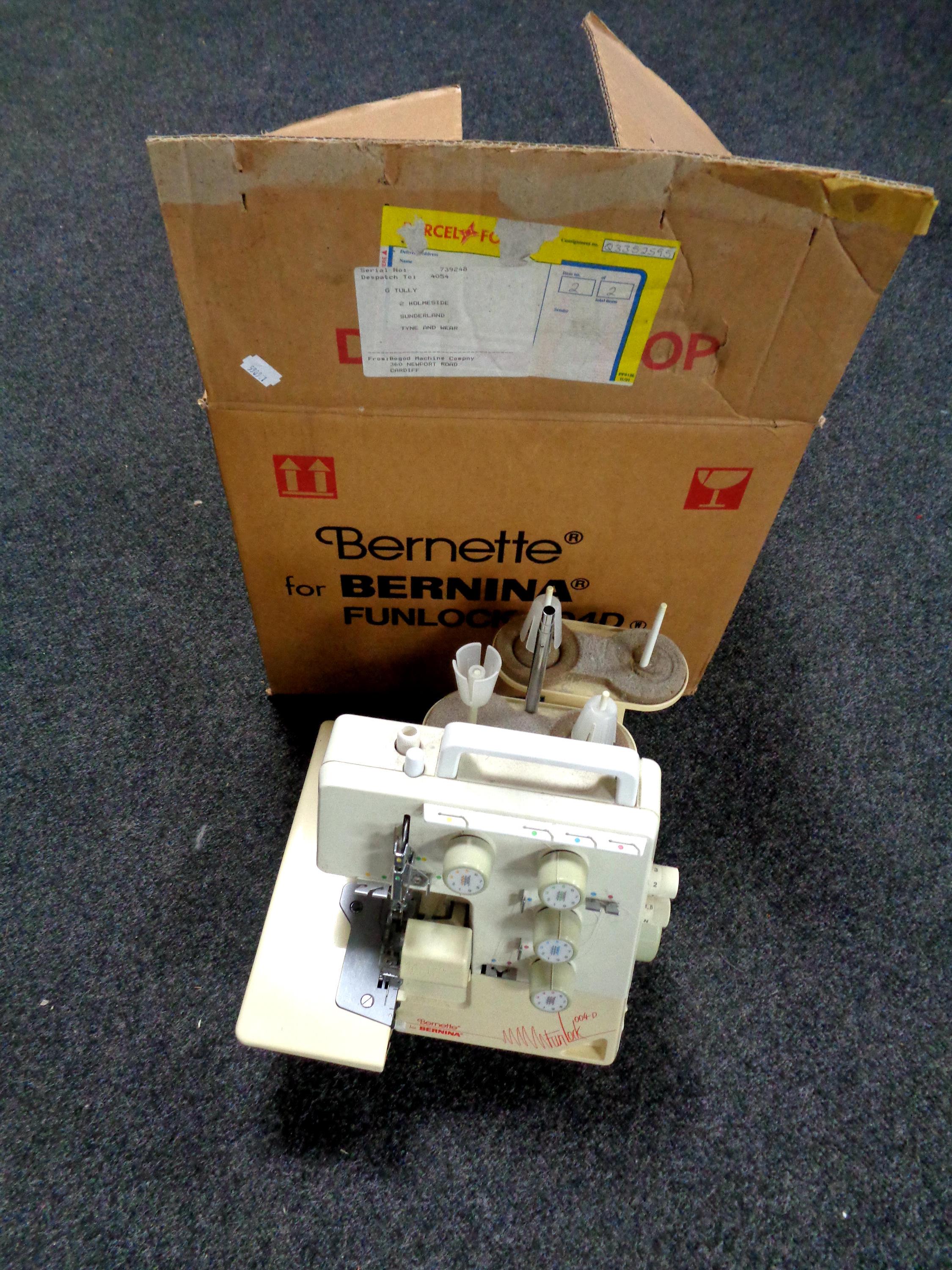 A Bernette For Benina sewing machine together with a further sewing machine case (empty) and a box