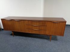 A mid 20th century teak low sideboard fitted three cupboards and three drawers CONDITION