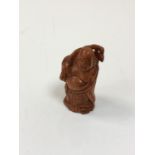 A carved Chinese hardwood netsuke - Gentleman holding a club