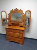 An Edwardian walnut three drawer dressing chest with triple mirror
