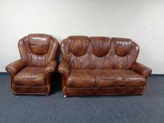 A brown leather three seater high back settee with matching armchair