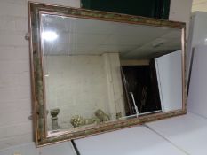 A contemporary bevelled overmantel mirror