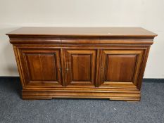 A Barker and Stonehouse triple door sideboard fitted three drawers