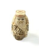 A carved Chinese bone netsuke - Elderly man holding a basket