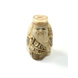 A carved Chinese bone netsuke - Elderly man holding a basket