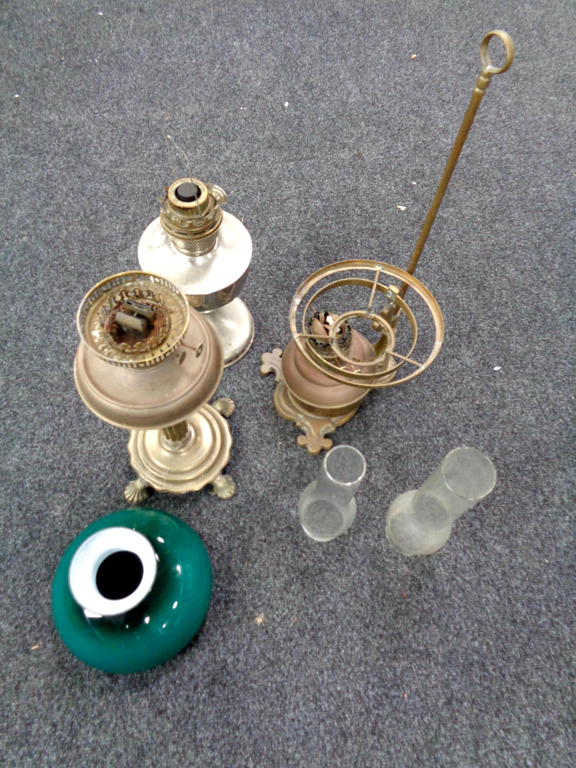 A tray containing three antique part oil lamps