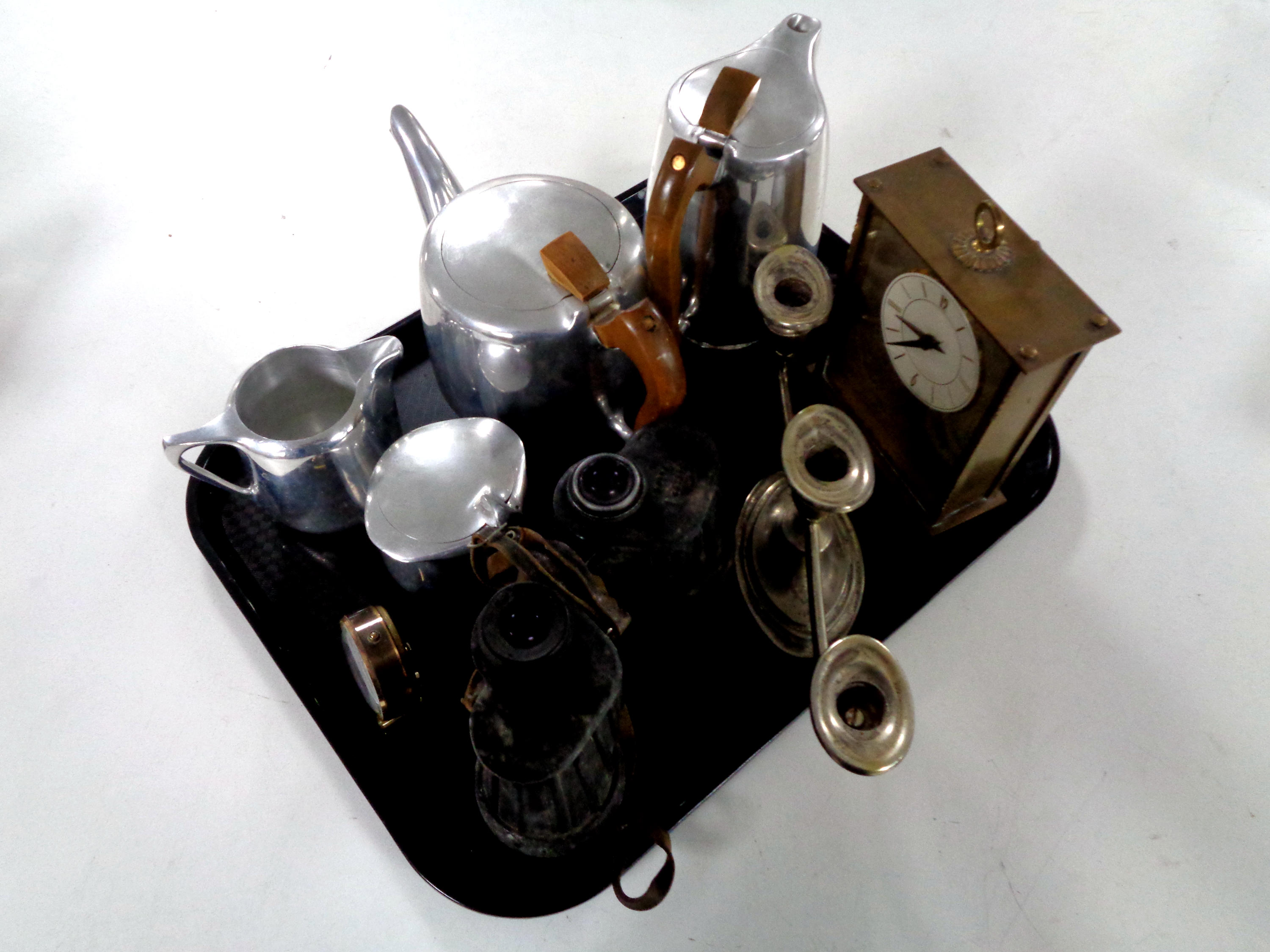 A tray containing four piece Picquot ware tea set, pair of Carl Zeiss binoculars, candelabrum,