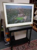 A contemporary black hall table together with a print of Chicago