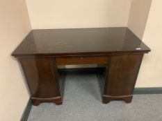 A 20th century twin pedestal desk fitted a drawer