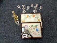 Two embroidered twin handled serving trays together with a pair of silver plated candelabra,