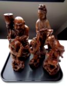 A tray containing a quantity of Chinese carved hardwood figures including large figure of Guanyin,