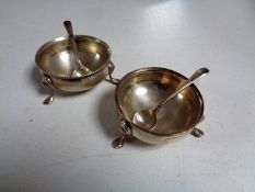 A pair of silver salts on hoof feet with spoons